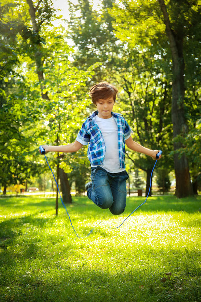 Cute little boy jumping rope  - Zdjęcie, obraz