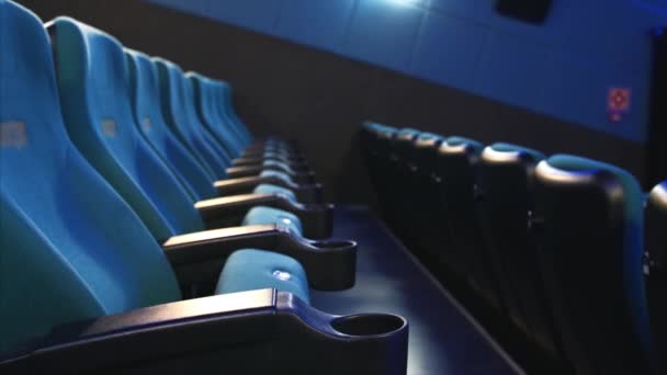 Close view of cinema seats in rows. Camera is sowly sliding sideways - Footage, Video