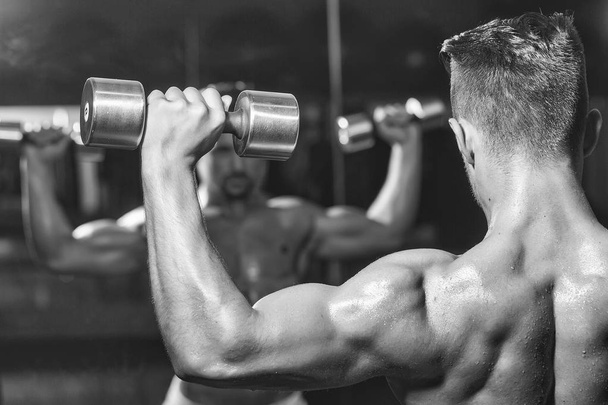 muscular man with dumbbell - Фото, зображення
