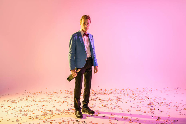 man with champagne standing on confetti - Fotoğraf, Görsel