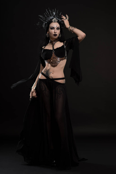 woman in gothic suit and horns crown - Fotó, kép