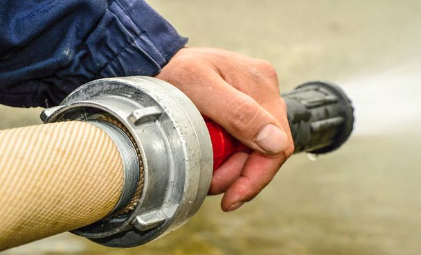 fire hose as a mud removal tool. - Photo, Image