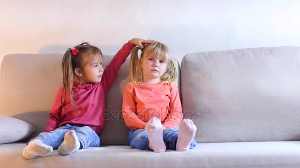 Little girl sitting on couch and crying, friend calms and embraces baby. - Footage, Video