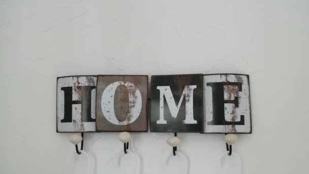 Cute stylish hanger on the wall of the house with cozy title - Footage, Video