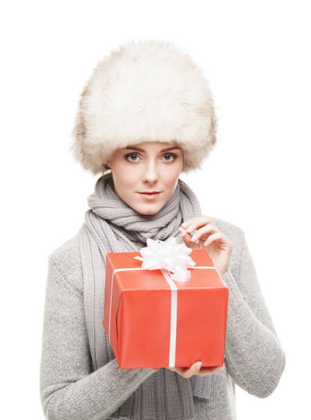 woman in fur hat with red gift  - Фото, зображення