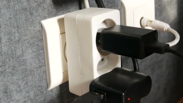 Many plugs in the wall outlet.Adapter charger in the wall outlet - Footage, Video
