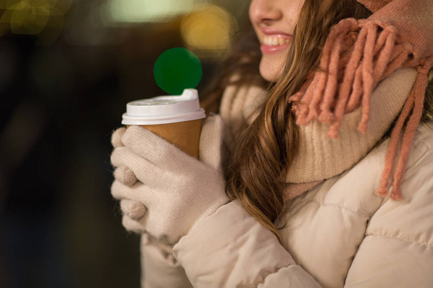 happy woman with coffee over christmas lights - 写真・画像