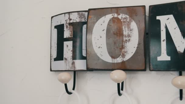 Cute stylish hanger on the wall of the house with cozy title - Footage, Video