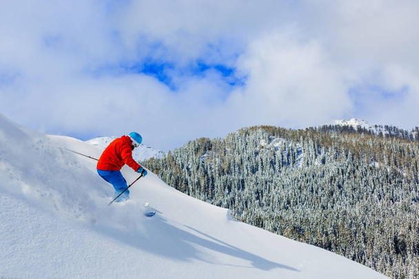 Man skiing on fresh powder snow in Italian Alps. - Zdjęcie, obraz