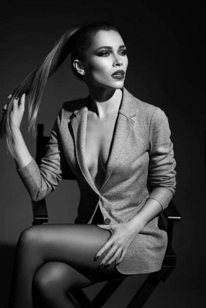 woman in jacket sitting on chair - Foto, Imagem