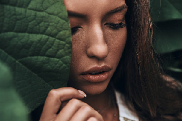 woman face among green leaves - Φωτογραφία, εικόνα
