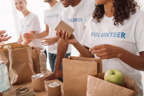 volunteers packing food and drinks for charity - Photo, Image