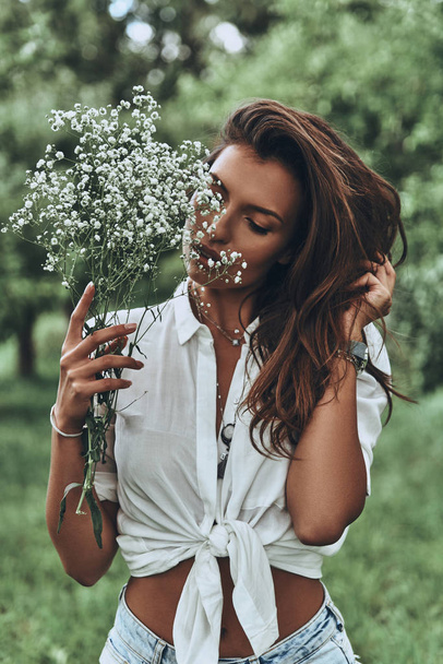brunette woman with field flowers - 写真・画像
