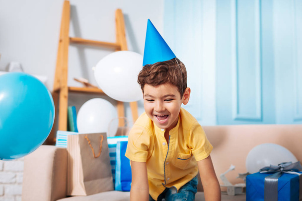 Happy little boy in party hat having fun - Фото, изображение