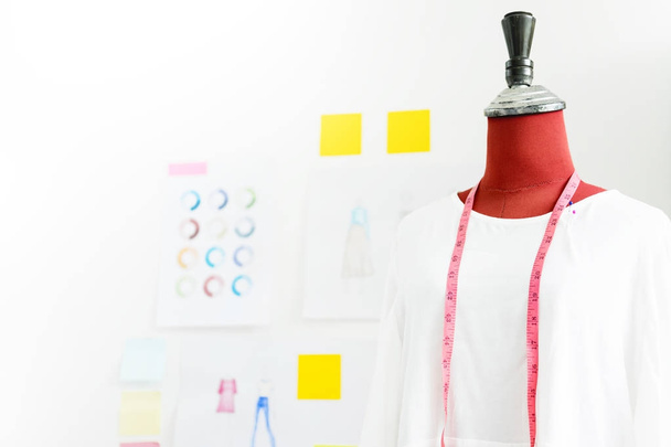 garment design on mannequin Red dummy with measuring tape in tai - Zdjęcie, obraz