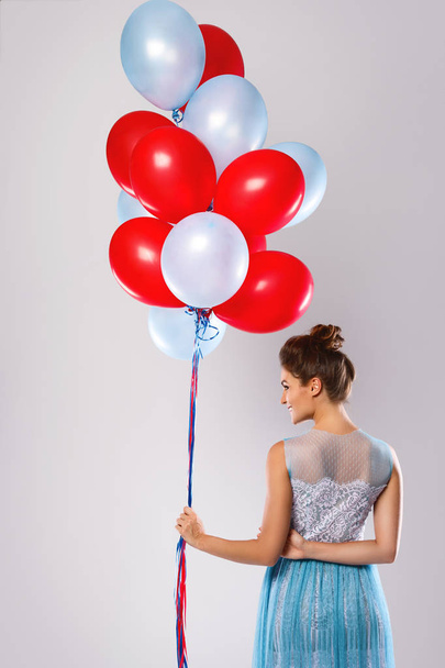 Young woman with colorful balloons - Foto, imagen