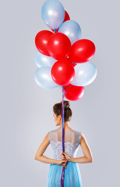 Young woman with colorful balloons - 写真・画像