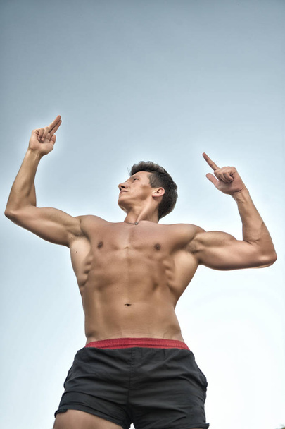 Man posing with bare muscular torso - Φωτογραφία, εικόνα