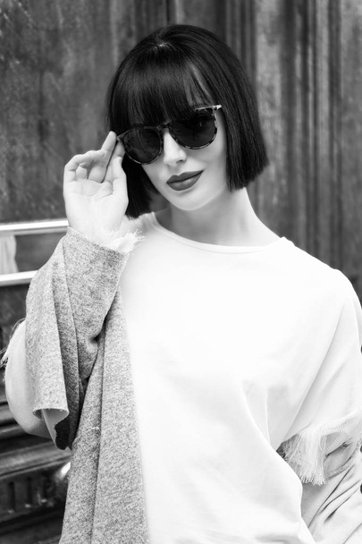girl in glasses with short brunette hair and red lips - Фото, зображення