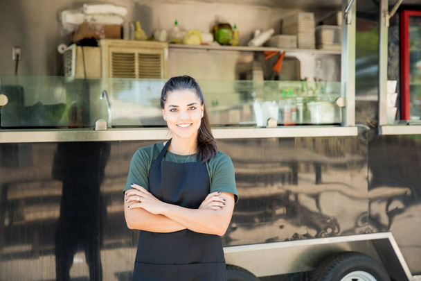 Pretty female chef with a food truck - Photo, Image