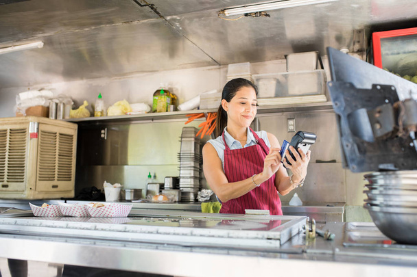 Swiping credit card in a food truck - Photo, Image