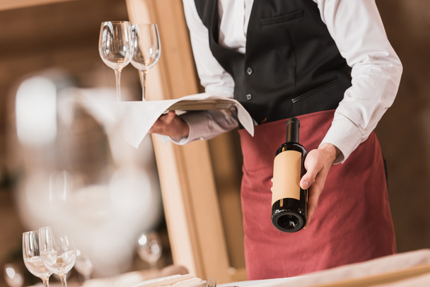 Waiter holding wineglasses and bottle - Photo, Image