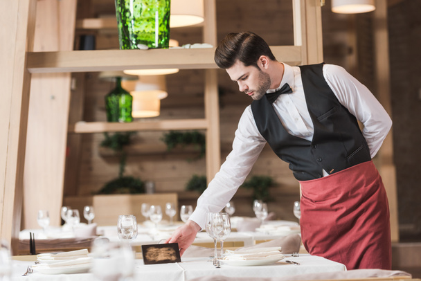 Waiter putting reserved sign - Photo, Image