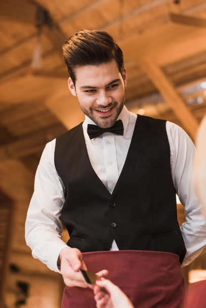 Customer giving credit card to waiter - Photo, Image