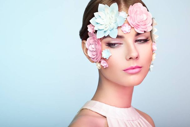 Face of beautiful woman decorated with flowers - Foto, Imagem