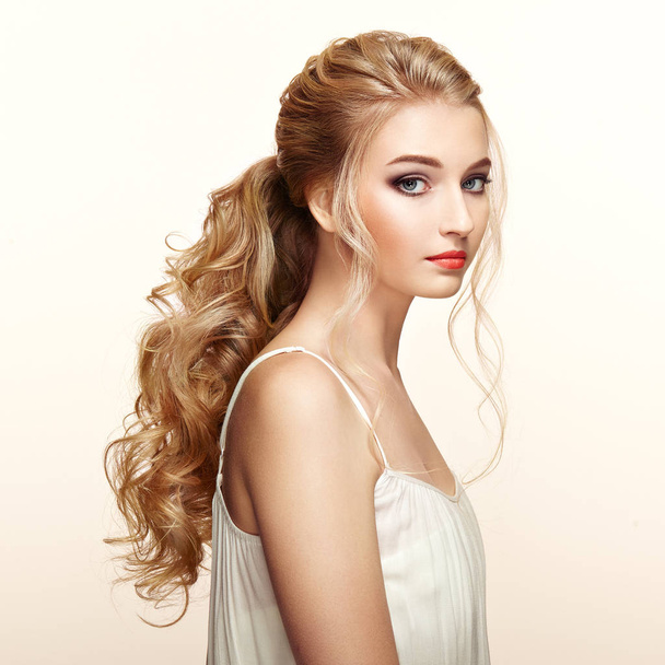 Blonde girl with long and shiny curly hair - Photo, image