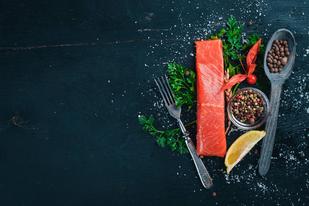 Salted salmon. Seafood. On a wooden background. Top view. Free space for your text. - Φωτογραφία, εικόνα