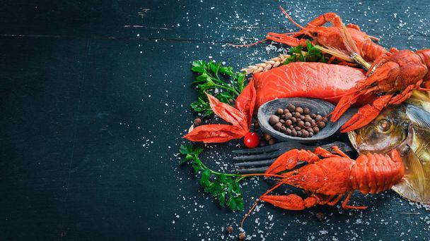 Seafood. Fish Vomer, lobster, salmon. On a wooden background. Top view. Free space for text. - Foto, imagen