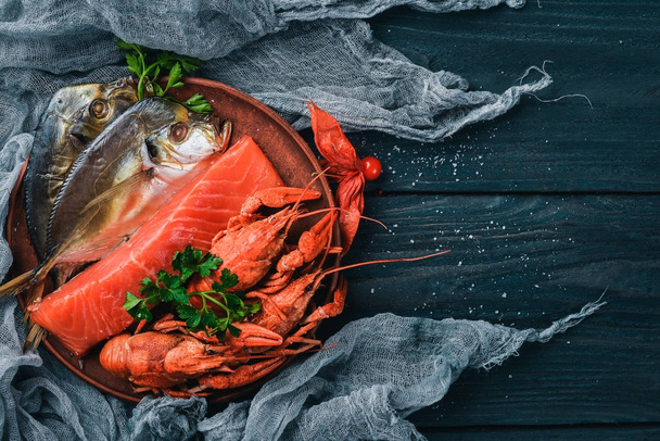Seafood. Fish Vomer, lobster, salmon. On a wooden background. Top view. Free space for text. - Valokuva, kuva