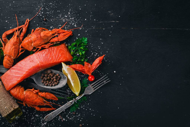 Seafood. Fish Vomer, lobster, salmon. On a wooden background. Top view. Free space for text. - Фото, зображення