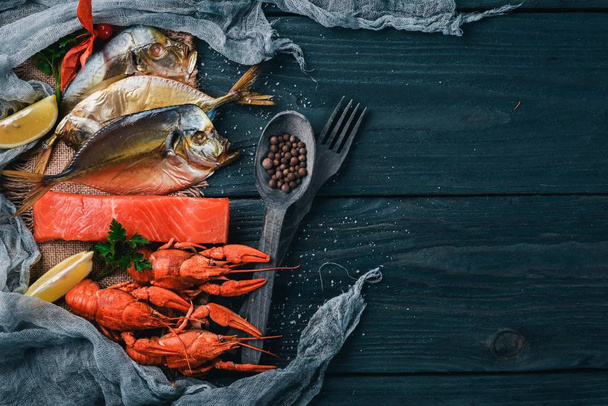 Seafood. Fish Vomer, lobster, salmon. On a wooden background. Top view. Free space for text. - Foto, Imagen