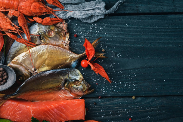 Seafood. Fish Vomer, lobster, salmon. On a wooden background. Top view. Free space for text. - Фото, изображение