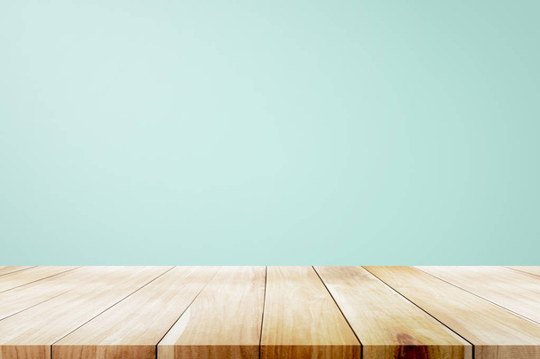 Empty wooden deck table over mint wallpaper background. - Photo, Image