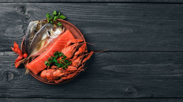 Seafood. Fish Vomer, lobster, salmon. On a wooden background. Top view. Free space for text. - Photo, Image