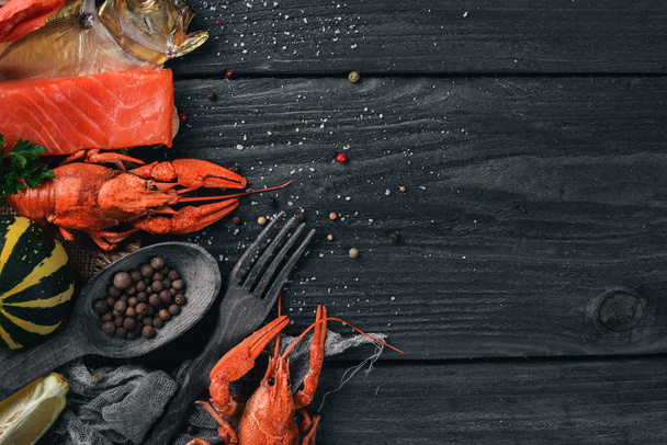 Seafood. Fish Vomer, lobster, salmon. On a wooden background. Top view. Free space for text. - Фото, зображення
