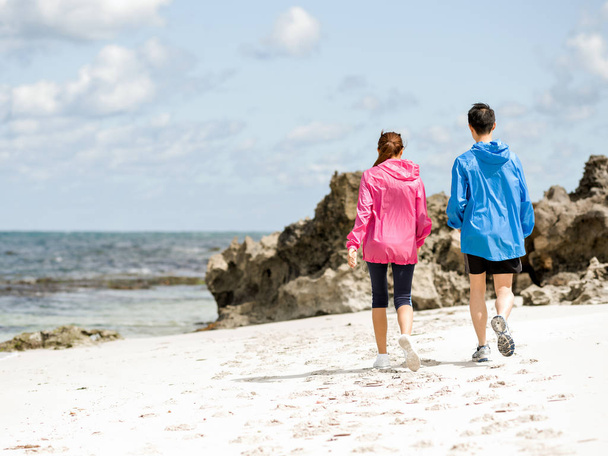 Young Couple Running along sea shore - Photo, image