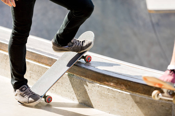 Teenage boy skateboarding outdoors - Fotó, kép