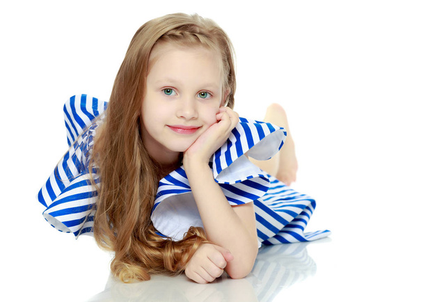 Adorable little blond girl in very short summer striped dress.Sh - Foto, immagini