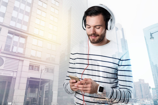 Positive young man listening to his favorite music - Photo, image