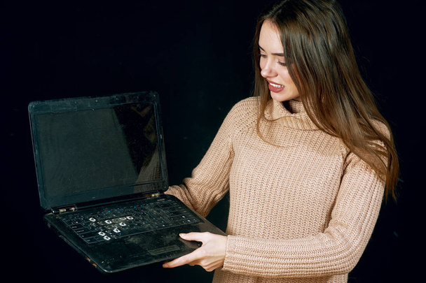 The young woman startled looks on the dirty system unit of computer - Foto, afbeelding