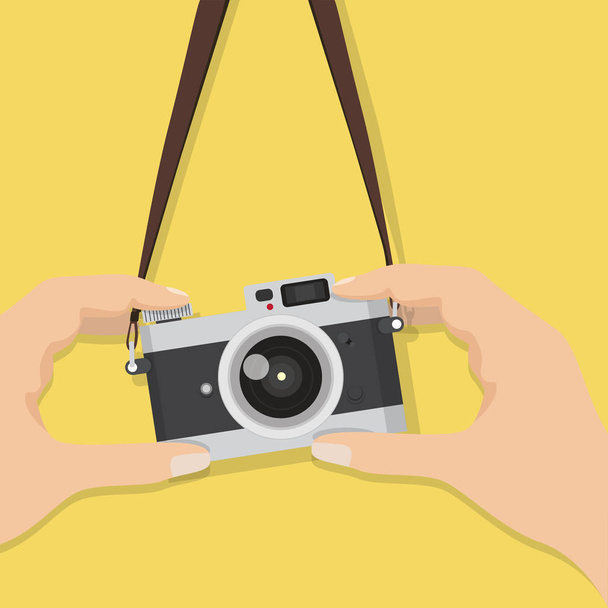 vintage camera with hand holding it - Vector, imagen