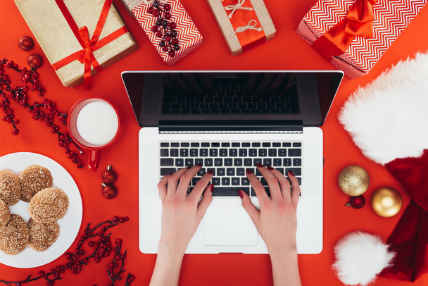 woman using laptop at christmastime - 写真・画像