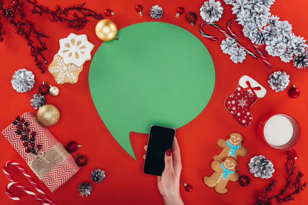 hand with smartphone and christmas speech bubble - 写真・画像