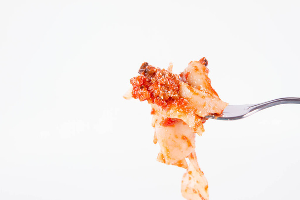 Pappardelle with bolognese on a fork on a white background - Φωτογραφία, εικόνα