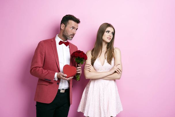 Man with roses and chocolate box apologizing fiance - Фото, изображение