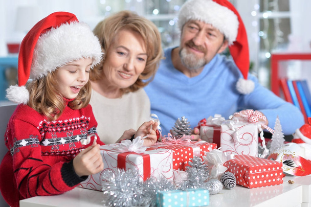 grandparents with granddaughter preparing for Christmas  - Foto, afbeelding